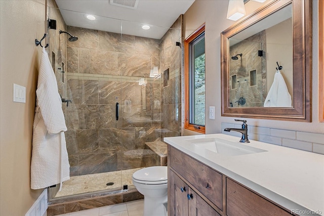 bathroom featuring visible vents, a stall shower, vanity, and toilet