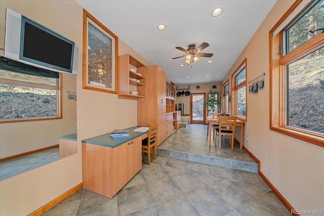 interior space with baseboards, a ceiling fan, and recessed lighting