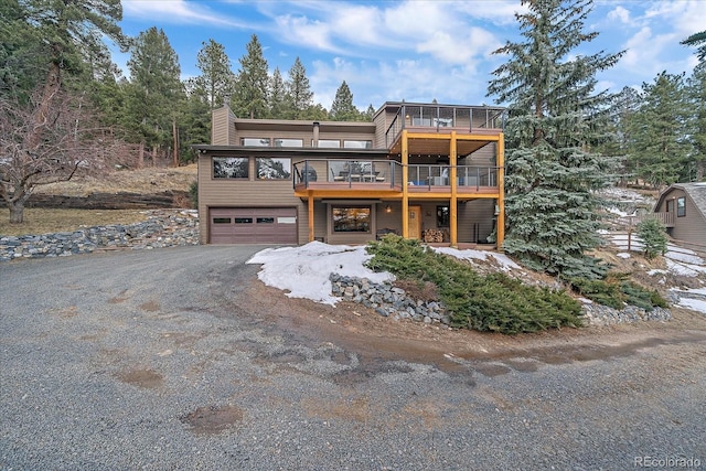 chalet / cabin featuring driveway and an attached garage