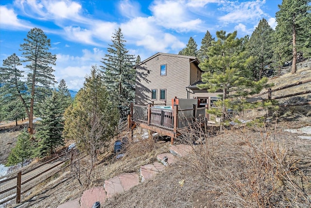 rear view of house featuring a deck