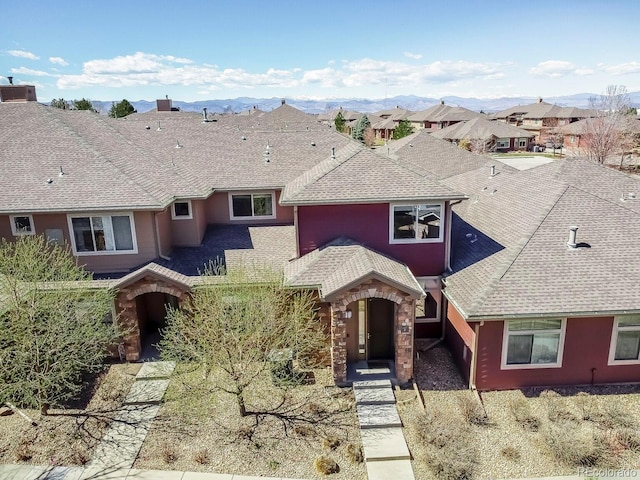 view of front facade featuring a mountain view and a shingled roof