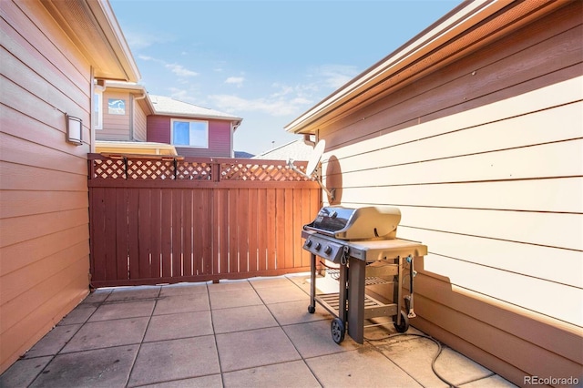 view of patio featuring grilling area and fence
