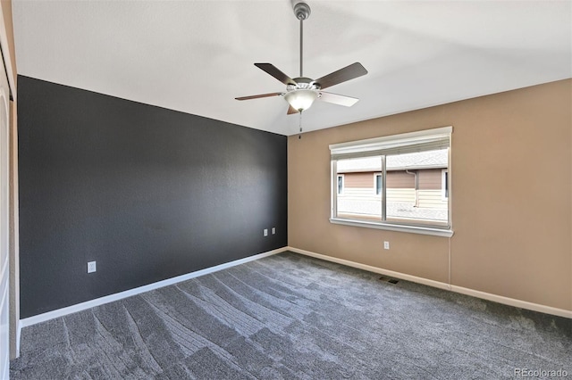 spare room with baseboards, ceiling fan, carpet flooring, and visible vents