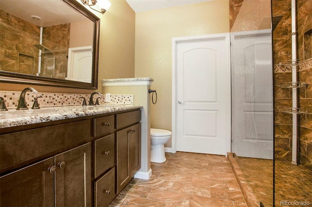 full bathroom with vanity, walk in shower, toilet, and tasteful backsplash
