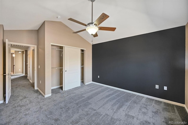 unfurnished bedroom featuring a closet, carpet, baseboards, and vaulted ceiling