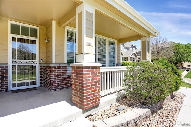 16062 E Geddes Dr Unit 150, Aurora, CO 80016 - doorway to property with covered porch and brick siding