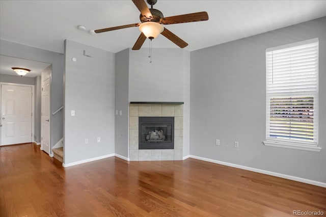16062 E Geddes Dr Unit 150, Aurora, CO 80016 - unfurnished living room with a ceiling fan, wood finished floors, baseboards, stairs, and a tile fireplace