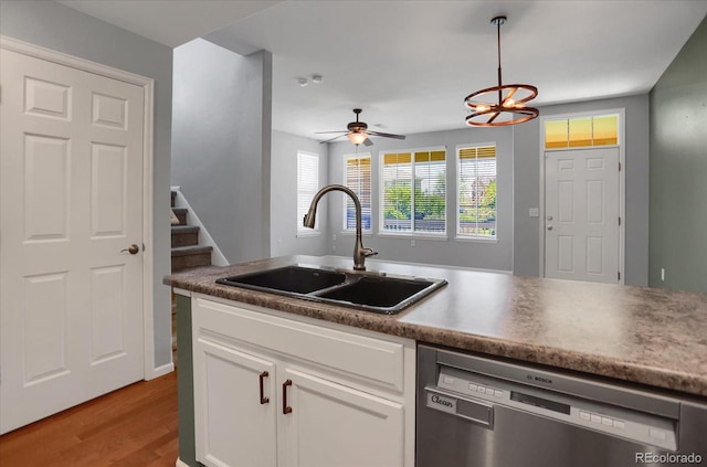 16062 E Geddes Dr Unit 150, Aurora, CO 80016 - kitchen with stainless steel dishwasher, a sink, white cabinetry, and light wood finished floors
