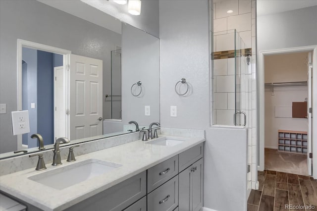 16062 E Geddes Dr Unit 150, Aurora, CO 80016 - full bath with wood tiled floors, double vanity, a shower with shower door, and baseboards