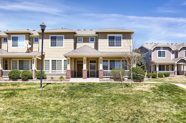 16062 E Geddes Dr Unit 150, Aurora, CO 80016 - view of front of house featuring a porch and a front lawn