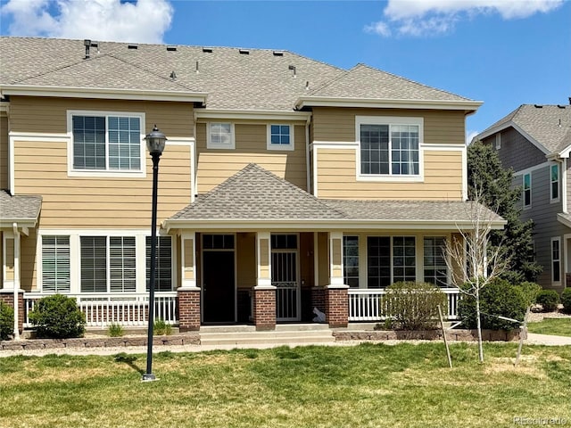 16062 E Geddes Dr Unit 150, Aurora, CO 80016 - view of front of house with a porch, a front yard, and a shingled roof