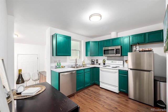 1803 E 36th Ave, Denver, CO 80205 - kitchen with stainless steel appliances, a sink, dark wood finished floors, and light countertops