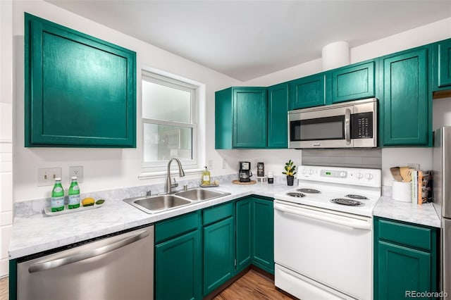 1803 E 36th Ave, Denver, CO 80205 - kitchen featuring appliances with stainless steel finishes, a sink, and light countertops