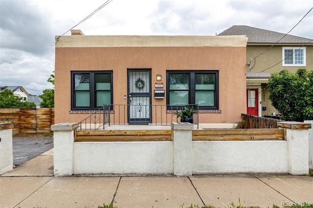 1803 E 36th Ave, Denver, CO 80205 - multi unit property featuring stucco siding, covered porch, and a fenced front yard