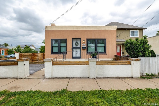 1803 E 36th Ave, Denver, CO 80205 - multi unit property with stucco siding, a fenced front yard, and covered porch