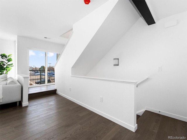 additional living space featuring wood finished floors and baseboards