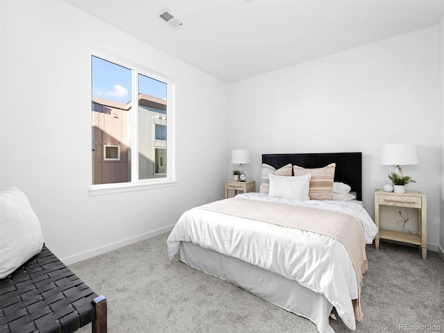 carpeted bedroom featuring baseboards