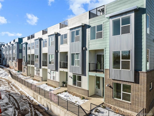 snow covered property featuring a residential view