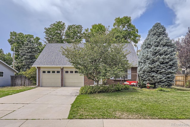 view of front of property with a garage and a front lawn