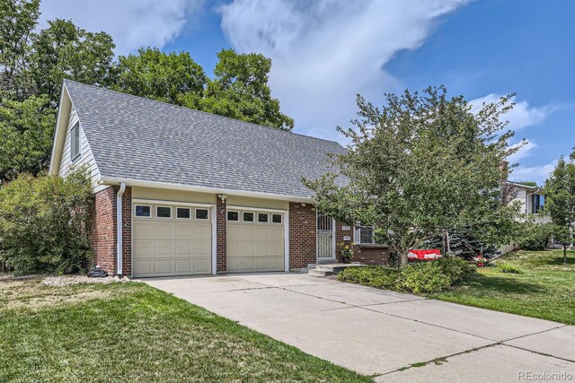 view of front of property featuring a garage and a front lawn