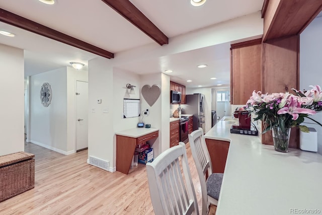 interior space featuring beam ceiling, light hardwood / wood-style floors, and sink