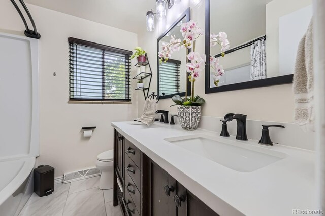 bathroom featuring vanity, tile patterned flooring, and toilet