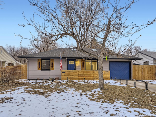 view of front of property with a garage, fence, roof with shingles, and concrete driveway