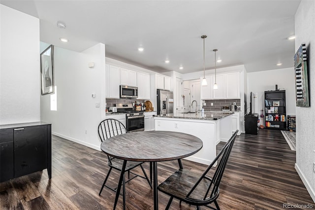 dining space with dark wood-type flooring and sink