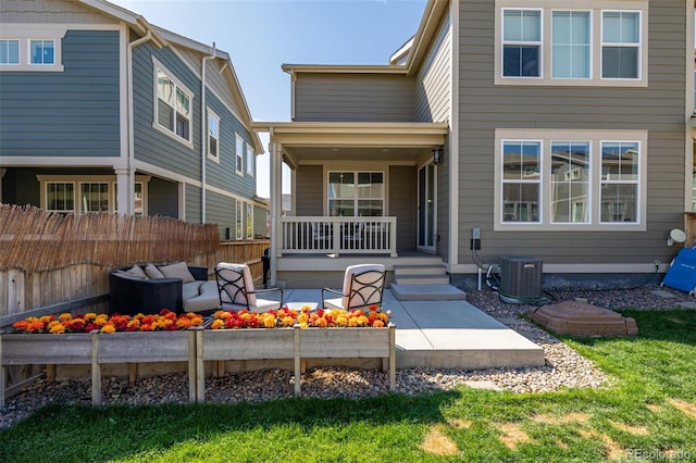 rear view of house with an outdoor living space, a patio, a yard, and central AC unit