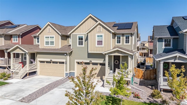 view of front of property with a garage and solar panels