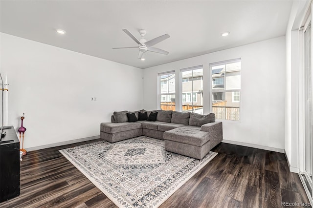 living room featuring dark hardwood / wood-style floors and ceiling fan