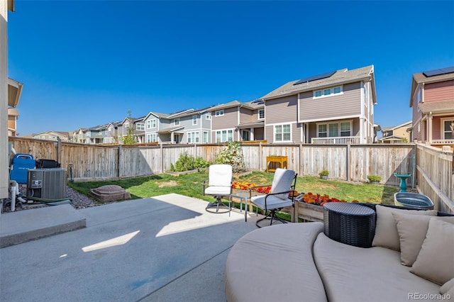 view of patio / terrace featuring a residential view, a fenced backyard, and central AC