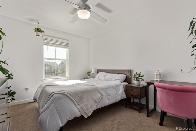 carpeted bedroom featuring a ceiling fan and baseboards