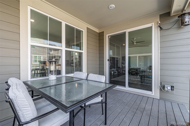 wooden terrace with outdoor dining space