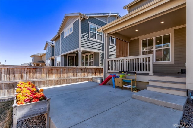 view of patio with covered porch and fence