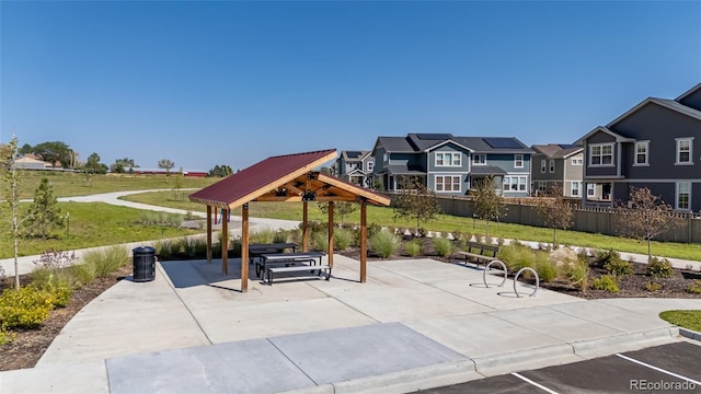 view of patio / terrace featuring a residential view, fence, and a gazebo