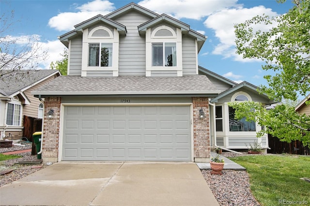 17943 E Bates Ave, Aurora, CO 80013 - view of front of property with brick siding, a shingled roof, an attached garage, and driveway