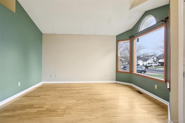 17943 E Bates Ave, Aurora, CO 80013 - spare room with lofted ceiling, light wood-type flooring, and baseboards