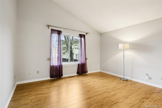 17943 E Bates Ave, Aurora, CO 80013 - spare room with vaulted ceiling, light wood finished floors, and baseboards