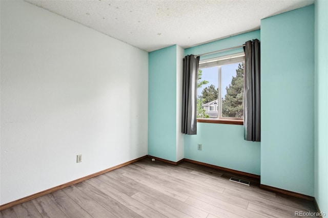 17943 E Bates Ave, Aurora, CO 80013 - empty room featuring wood finished floors, baseboards, and a textured ceiling