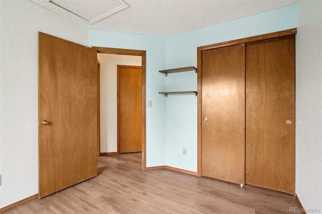 17943 E Bates Ave, Aurora, CO 80013 - unfurnished bedroom featuring light wood-type flooring, attic access, a closet, and baseboards