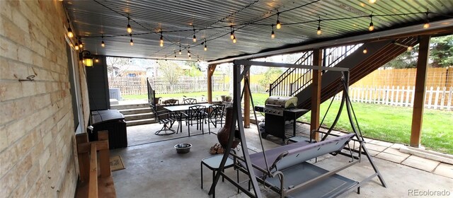 view of patio / terrace with grilling area, outdoor dining area, and a fenced backyard