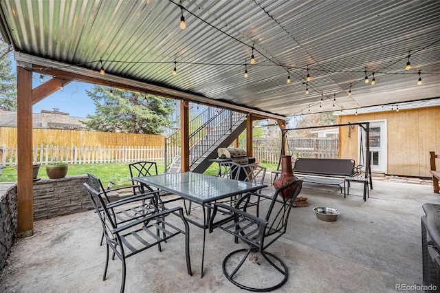 12175 W 68th Pl, Arvada, CO 80004 - fenced backyard featuring outdoor dining area, stairway, a patio, and area for grilling