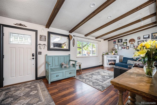 12175 W 68th Pl, Arvada, CO 80004 - entryway featuring a textured ceiling, wood finished floors, and a glass covered fireplace