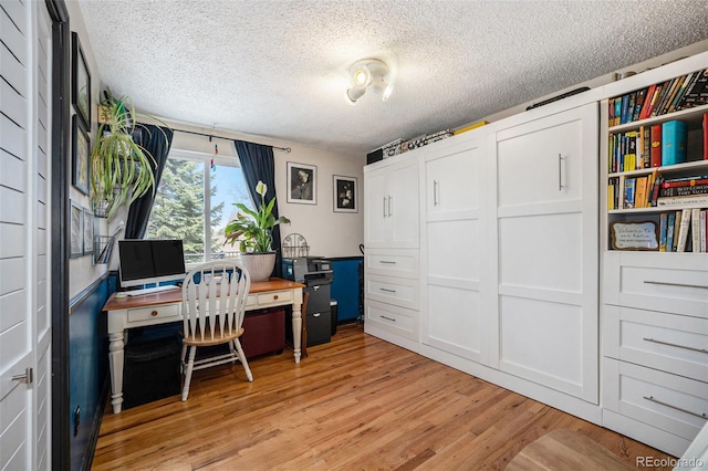12175 W 68th Pl, Arvada, CO 80004 - home office with light wood-style floors and a textured ceiling