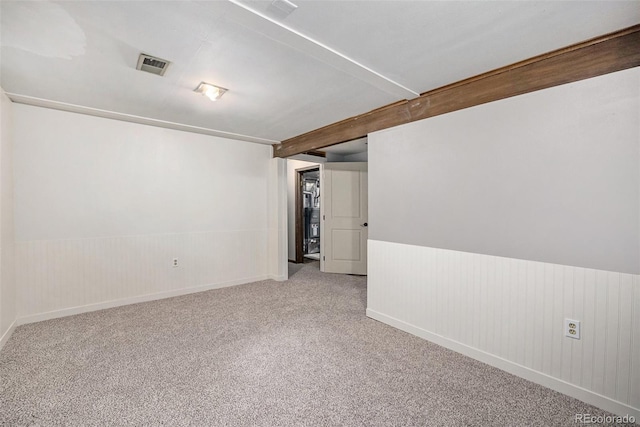 12175 W 68th Pl, Arvada, CO 80004 - carpeted spare room with wainscoting, beamed ceiling, and wooden walls