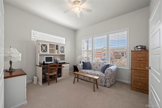 carpeted office featuring ceiling fan