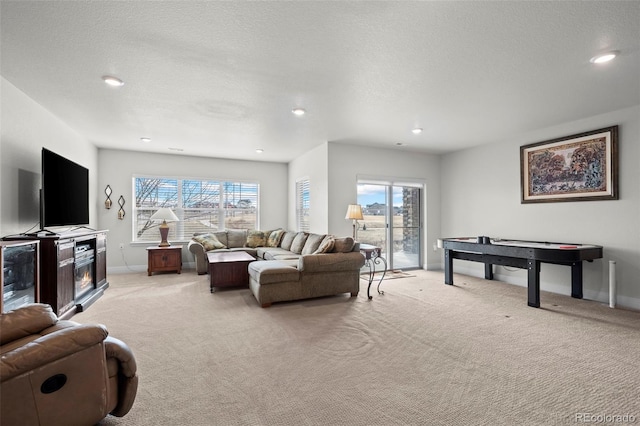 living room featuring light carpet and a textured ceiling