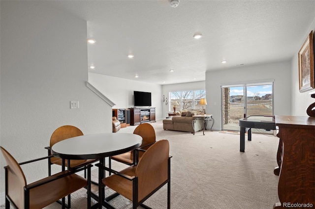 dining area with light colored carpet