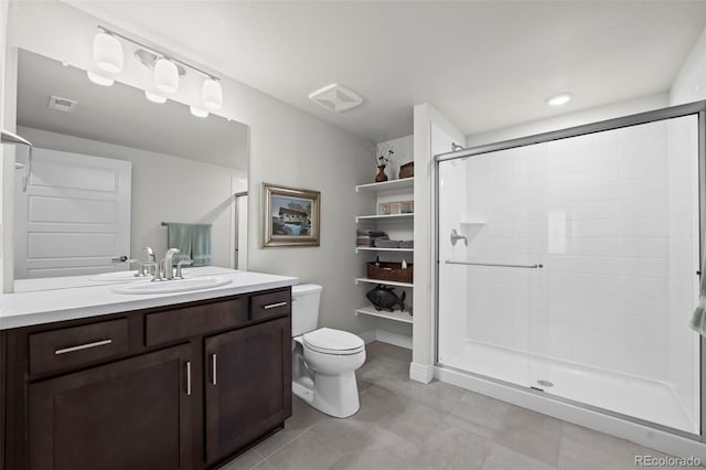 bathroom featuring a shower with door, vanity, and toilet